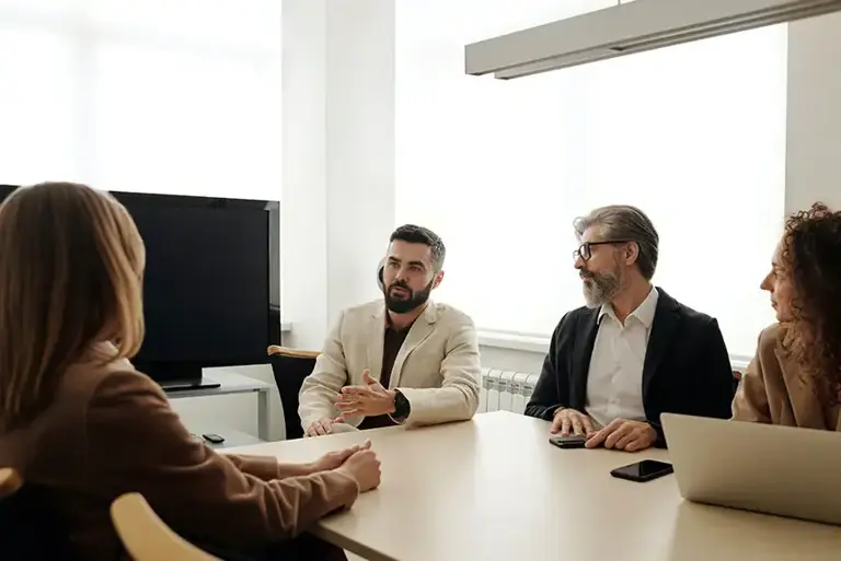 The lead of three interview panel members talk to the interviewee