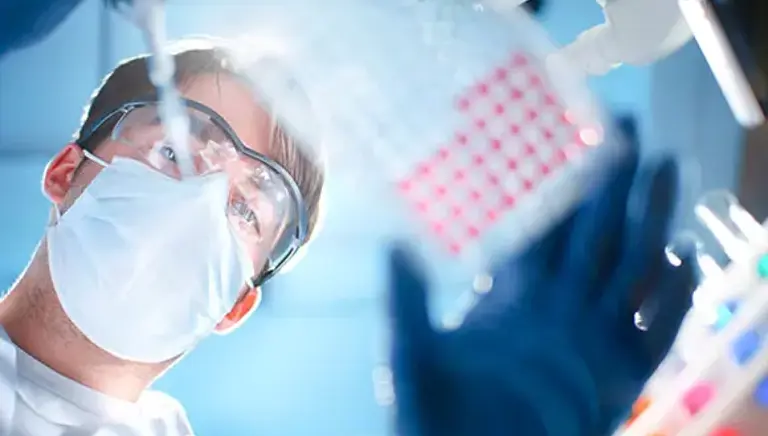 View looking up at a scientist using a pipette