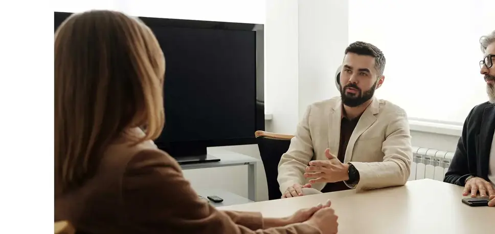 The lead of three interview panel members talk to the interviewee