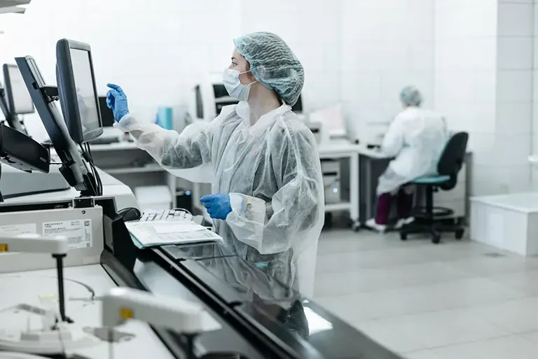 Scientist inputting on a touch screen in a laboratory